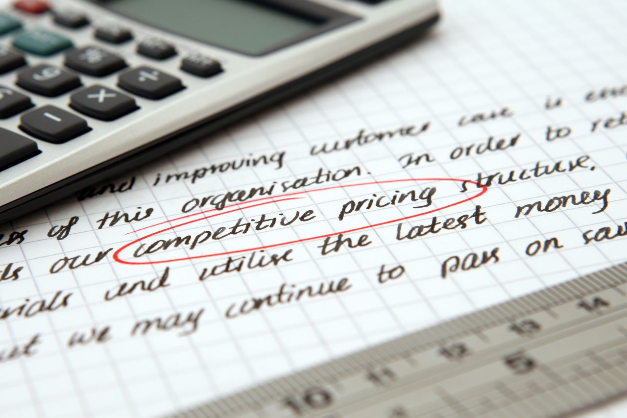 testimonials-img Focused image of handwritten business notes with calculator emphasizing pricing strategy.